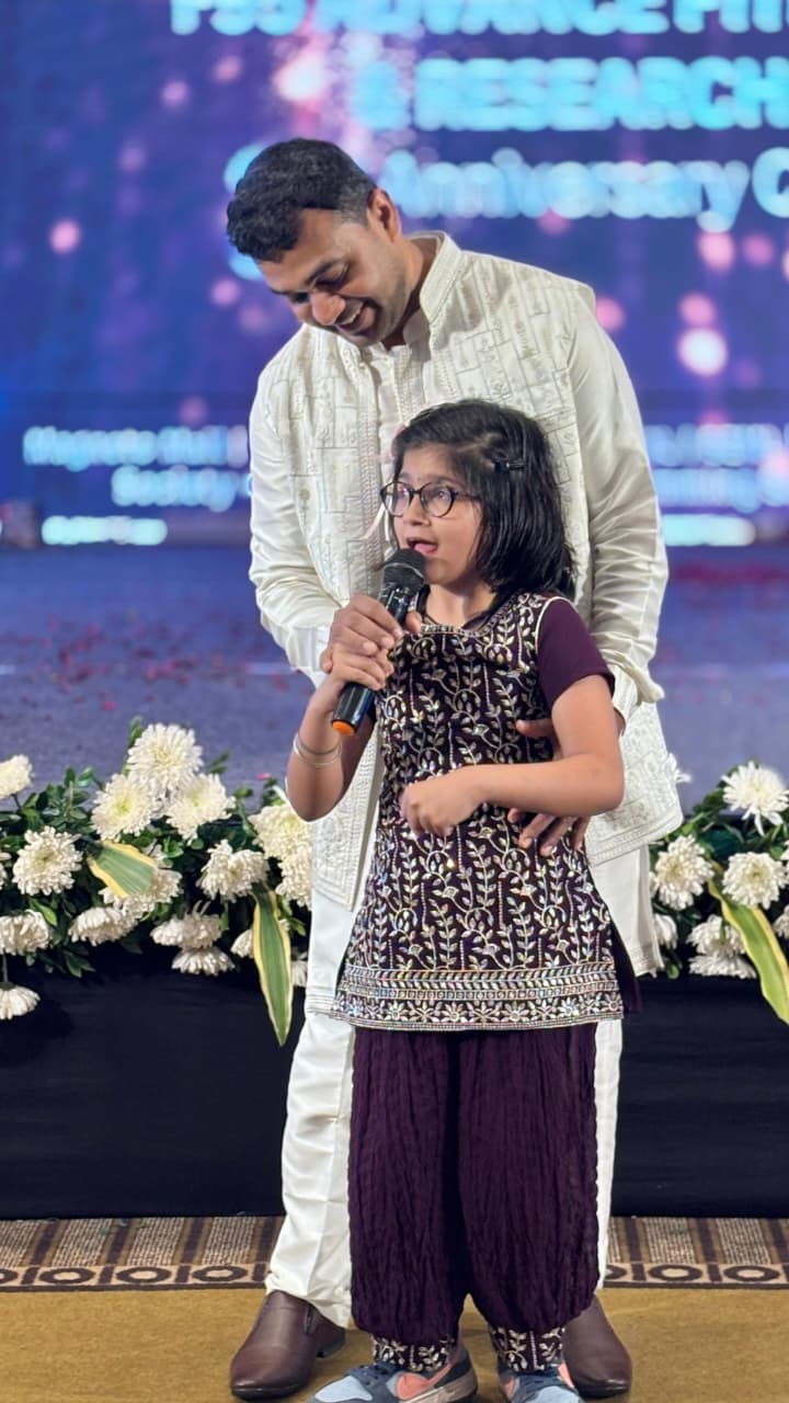 Physiotherapist performing ergonomic assessment for factory worker